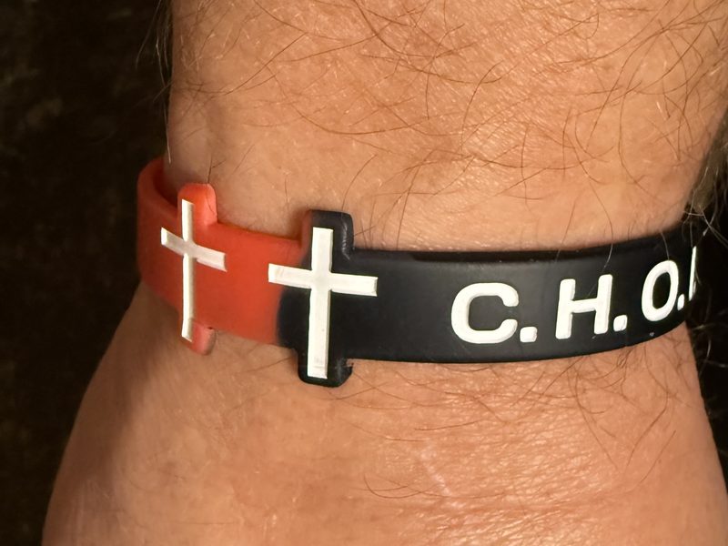 CHOICES wristband with three crosses worn on a wrist